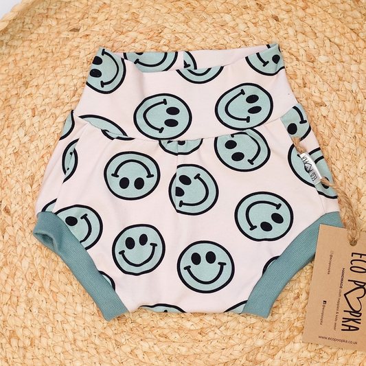 Eco Poopka handmade baby bummies shorts with green smiley face print, made from soft cotton blend fabric and designed to fit over cloth nappies.
