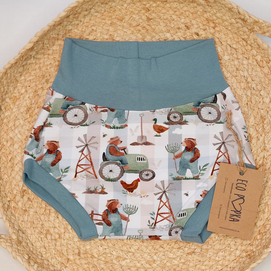 Handmade baby bummies in a farm-themed print, featuring soft, stretchy cotton fabric and designed to fit comfortably over cloth nappies.
