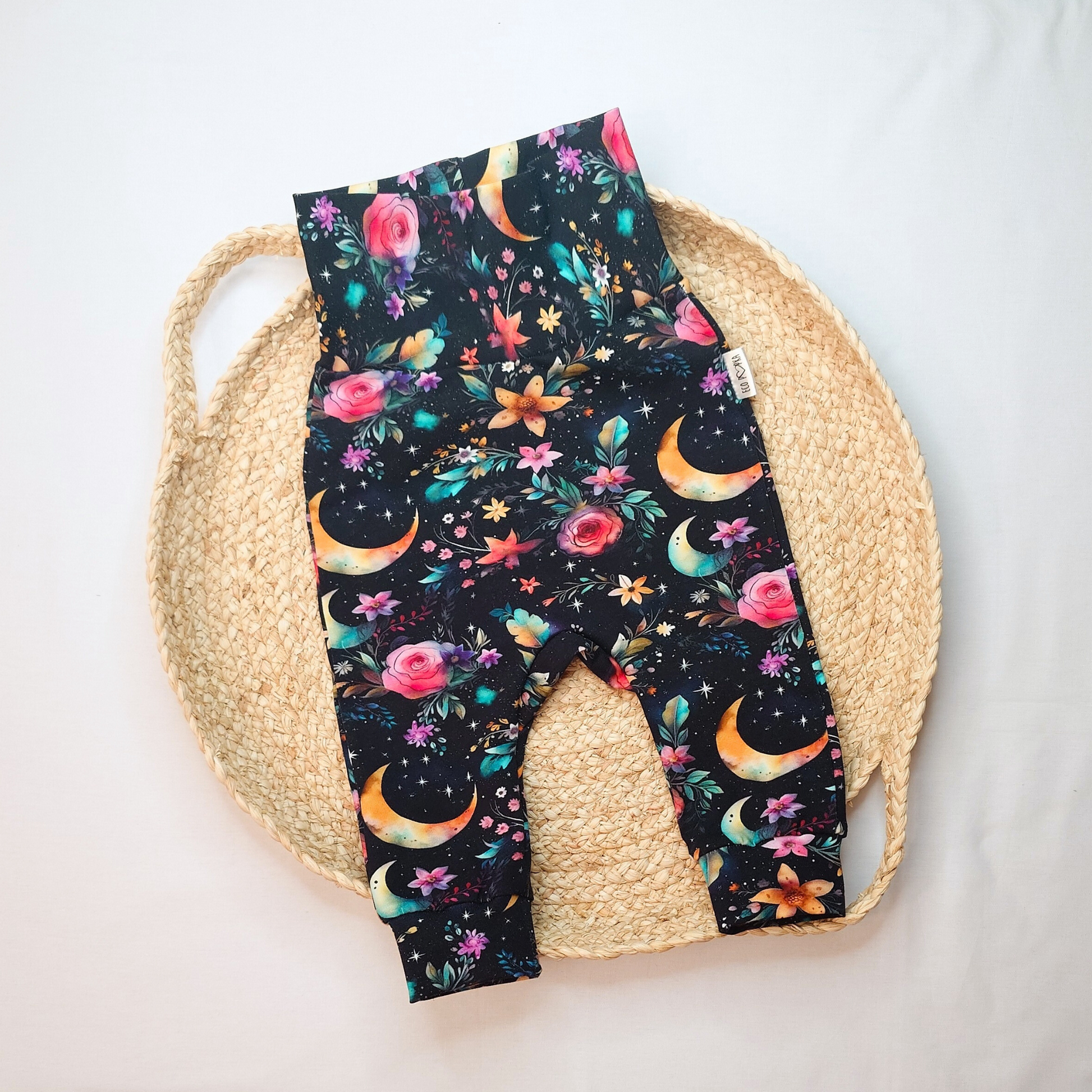 Handmade grow with me pants for babies and toddlers, featuring a celestial floral Moon Garden print in vibrant colours. Soft, stretchy cotton fabric.