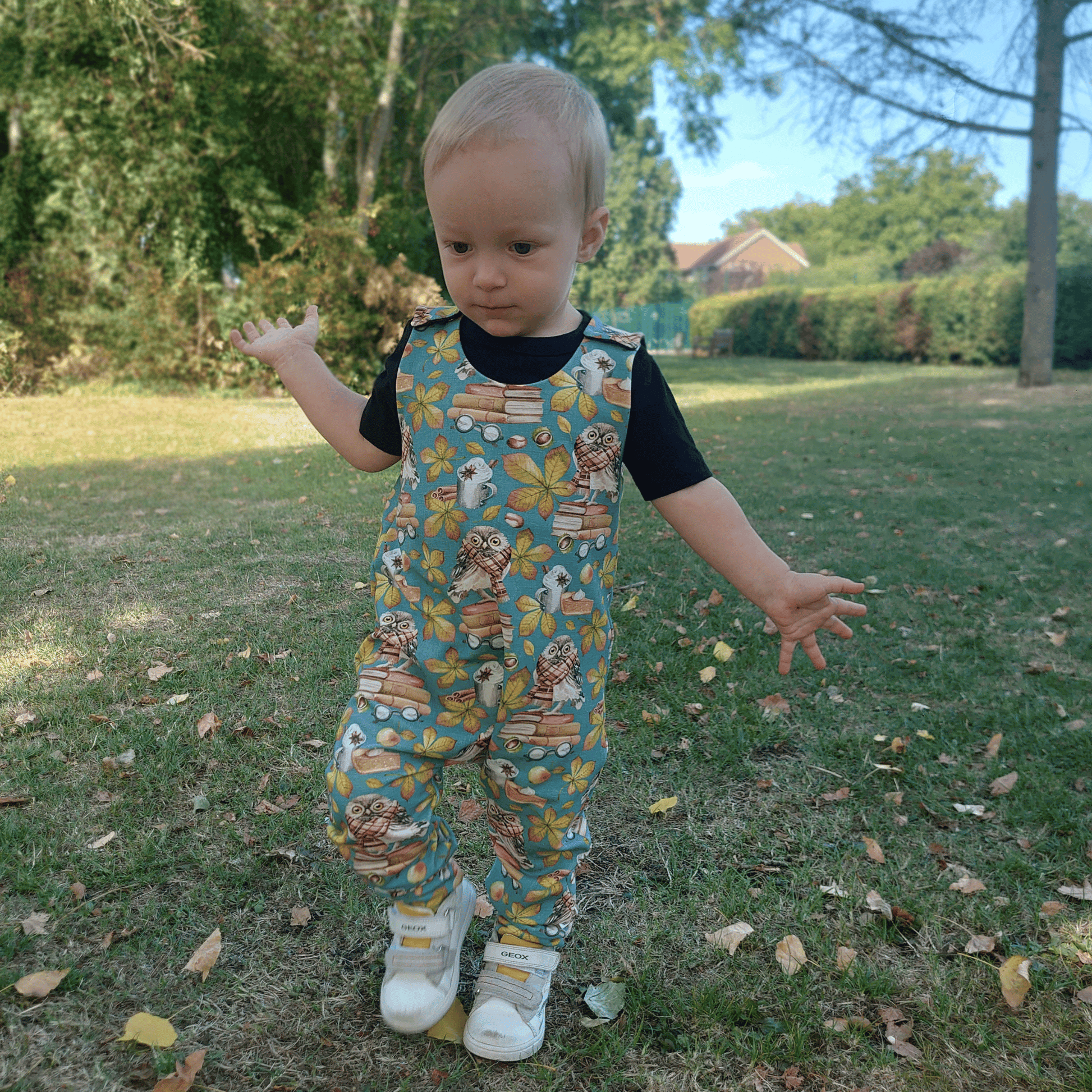 Boy wearing petrol blue romper with charming owl print, ideal for stylish and comfy everyday wear. front view